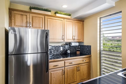 Kitchen with stainless steel appliances and sleek backsplash