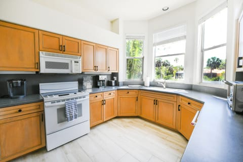 Bright windowed kitchen overlooks your beautiful backyard and the canal.
