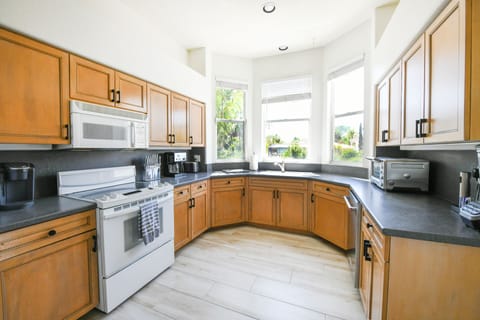 Extra large kitchen is fully-equipped with appliances, cookware and dinnerware.