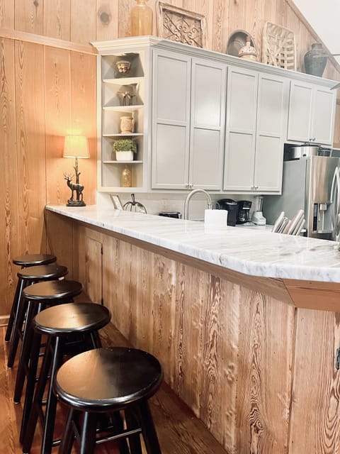 There are several bar stools around the kitchen island. Great spot for the kids.