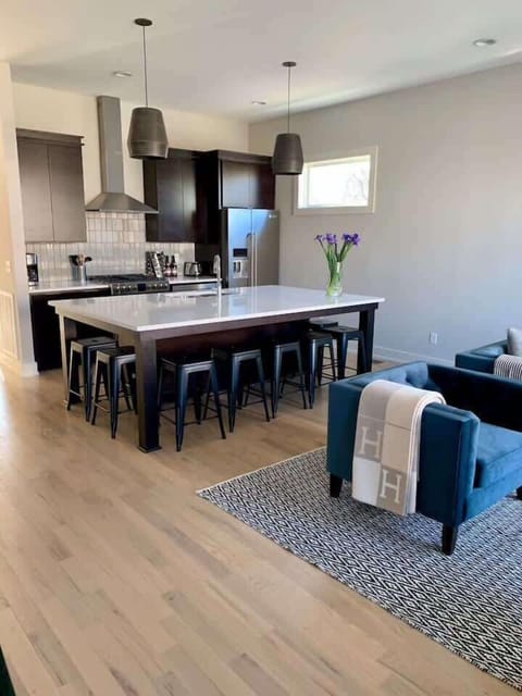 Chef's Kitchen with massive island and seating for 10 opens to large living room