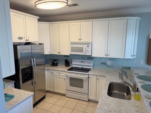 Fully equipped kitchen with blender, keurig, coffee pot, and slow cooker.