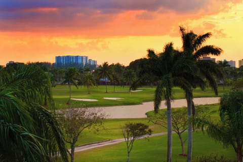 Soak in golden sunsets over lush greens and palms.