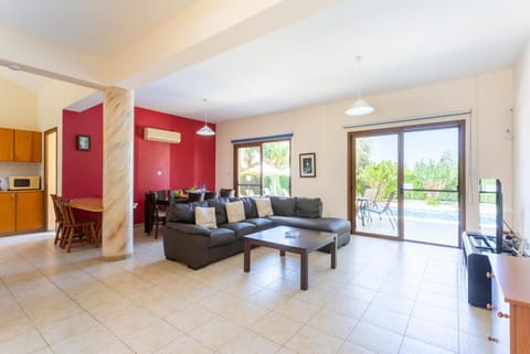 Open-plan living room with sofas, dining area, kitchen, A/C, WiFi internet, satellite TV, and terrace access