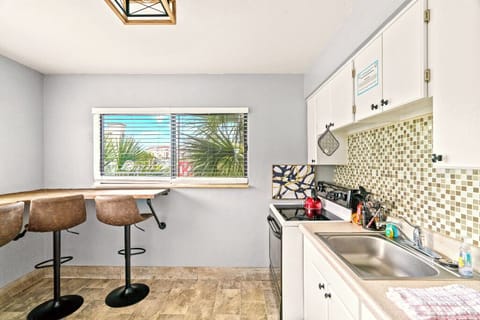 Boutique Beach Retreat Full Size Kitchen and seating area with Refrigerator  Oven Range, Coffee Maker Utensils, dishes and cooking basics