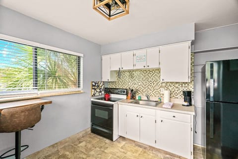 Boutique Beach Retreat Full Size Kitchen and seating area with Refrigerator  Oven Range,  Coffee Maker Utensils, dishes and cooking basics
