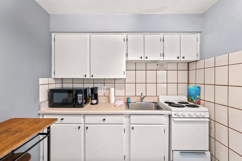 Boutique Beach Retreat Treasure Island full kitchen, stove refrigerator, freezer, microwave, coffee maker, kitchen utensils and flatware kitchen table