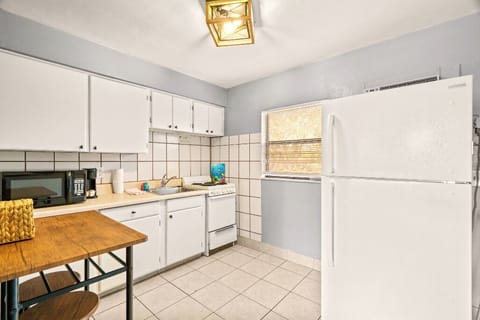 Boutique Beach Retreat Treasure Island full kitchen, stove refrigerator, freezer, microwave, coffee maker, kitchen utensils and flatware kitchen table
