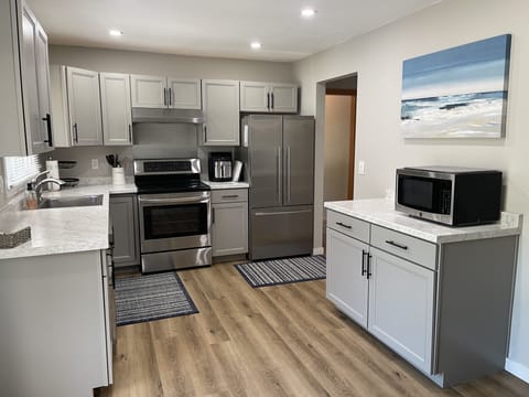 Updated kitchen with new cabinets and stainless appliances.