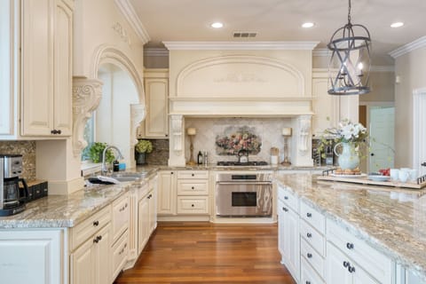 Chef's kitchen with a large island counter and modern appliances.