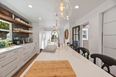 Kitchen Sink Island with View toward Living Room and West Oceanview Deck