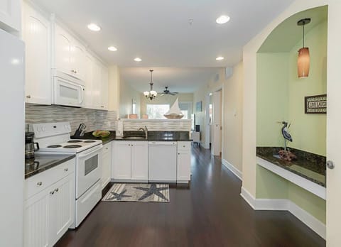 The kitchen - microwave, dishwasher, full size fridge, pots/pans, dishes and a Mr. Coffee