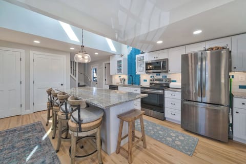 Spectaular Kitchen with Stainless Appliances and gleaming Quartz Countertops.