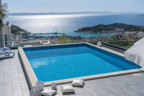 Breathtaking sunset views in a stylish 5-bedroom villa, with a private 32 sqm pool, 4 bathrooms, 2 living rooms, and 2 kitchens