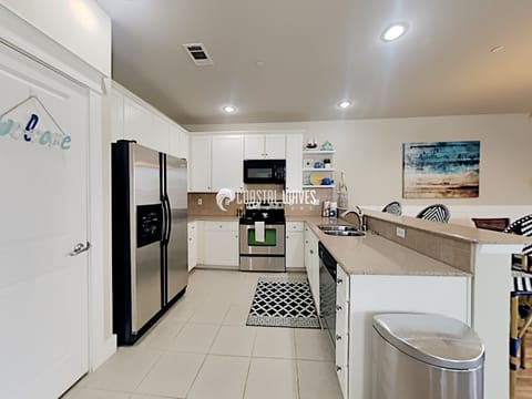 Kitchen overlooks dining, living and balcony views