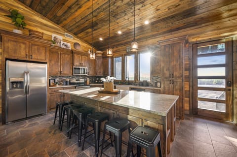 You are seamlessly taken into the kitchen which has 6 bar top seats!