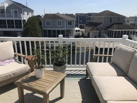Back porch overlooking canal with couch & 2 chairs