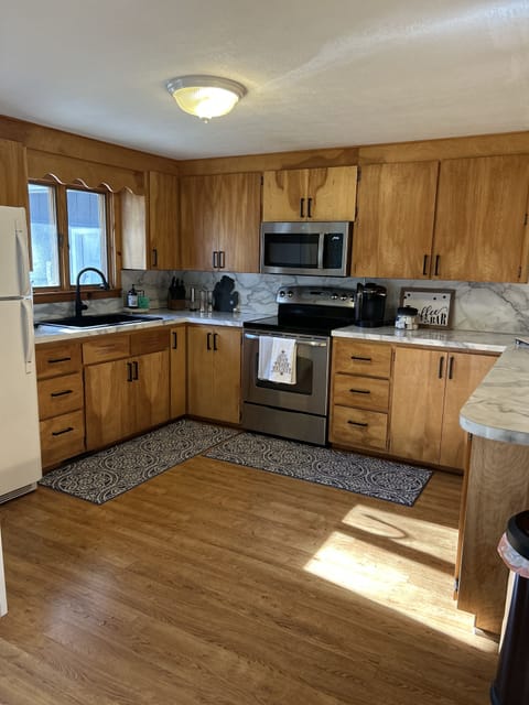 Large open kitchen with all the things you would need for cooking meals. 