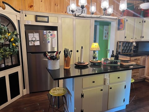 Original corner china cabinet. Stocked with tumblers, wine glasses, etc.