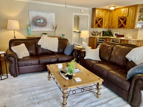 Open Living area next to dining area with two wine fridges. 