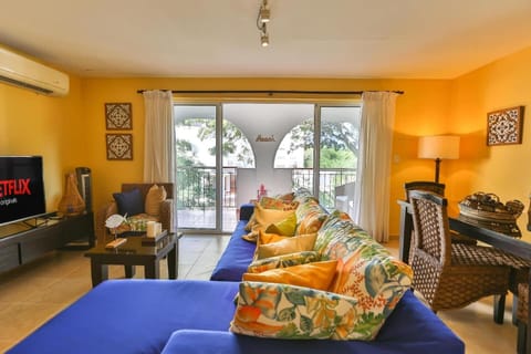 Living room includes full kitchen, smart tv, balcony, washer and dryer