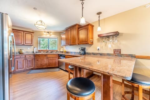 Kitchen with stainless steel appliances, granite countertops, and bright, open feel.
