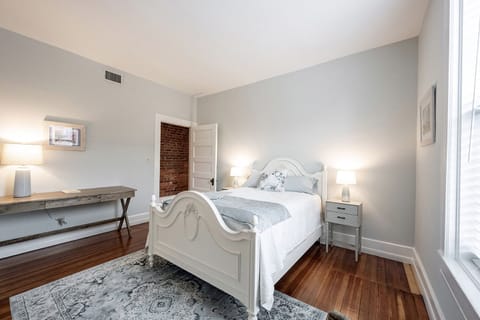 Bedroom 1 with double bed and large work desk and chair.