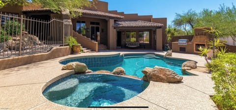 Resort style yard with built in grill and lunge area 