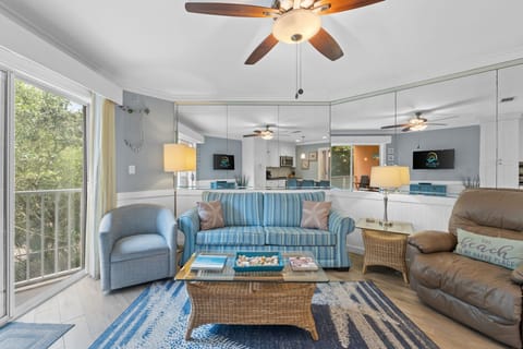 Living room featuring fresh decor done in coastal colors and art. Flat screen TV w/cable.