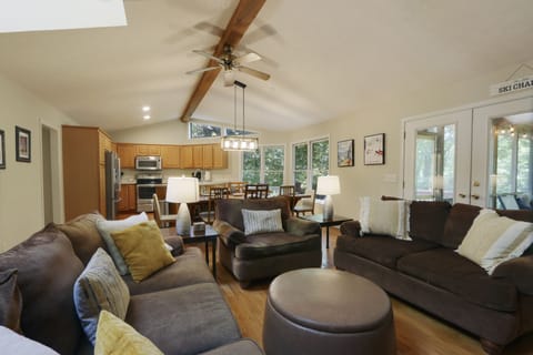 Open floorplan with hardwood floors and cathedral ceilings.