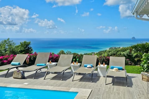 Enjoy the present moment at Villa Carpe Diem. An exceptional solarium area with designer sun loungers and a private pool, offering breathtaking panoramic views of the Caribbean Sea and Diamond Rock.