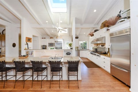 Incredible chef`s kitchen with high end six burner gas range, bar seating and upgraded stainless steel appliances