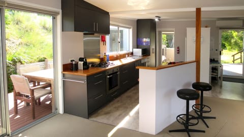 Bright and open fully-equipped kitchen overlooking the northern sundeck.