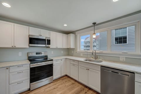 Well-Stocked Kitchen with Stainless Appliances and stunning Quartz Countertops.