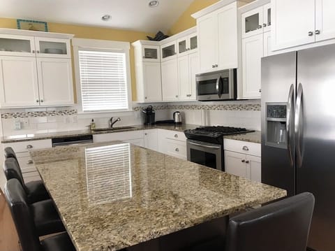 Large island for food preparation and gathering. 