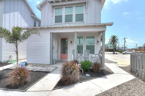 Charming coastal cottage with covered porch and modern beachside styling in a quiet neighborhood setting.