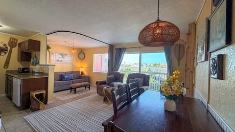 Settle into your spacious suite where warm colors and comfortable seating create the perfect home base for your vacation adventures.