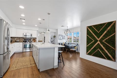 Updated stainless steel kitchen, kitchen island, dinning room view