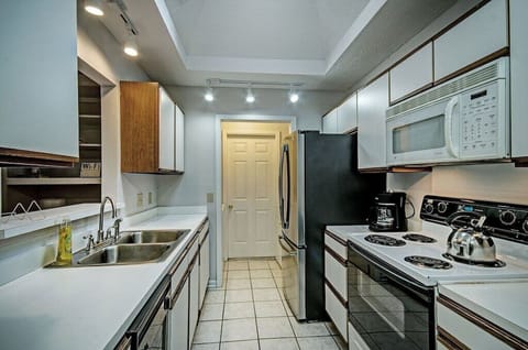 The kitchen with a new, large refrigerator, stove/oven, dishwasher, microwave, 12 cup programmable coffee pot, kettle, and toaster. Perfect for long stays.