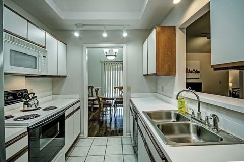 In the kitchen, there is plenty of dishware, glassware, silverware, and utensils