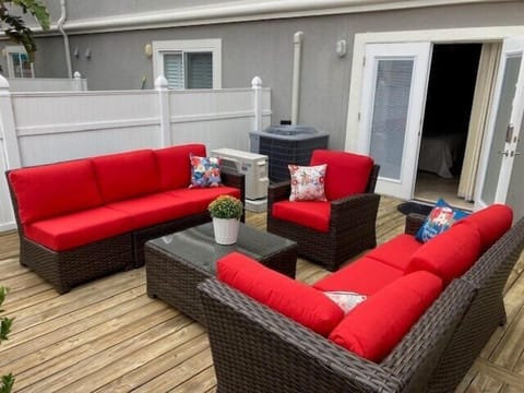 - Unwind on the private deck featuring bold red cushioned seating, rattan frames, and a matching coffee table
- Perfect for evening chats, reading under the sun, or a group hangout
- Access this inviting outdoor lounge directly from the bedroom