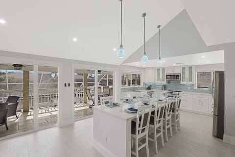 8 seat Quartz topped island kitchen with LED lighting, stainless steel appliance