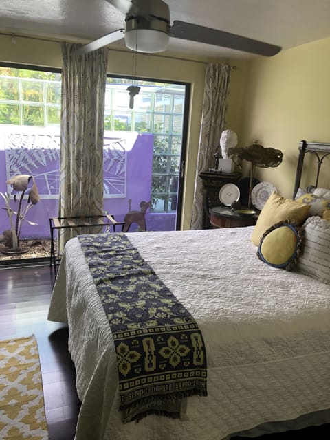 Sunlit Queen Bedroom with private garden view.