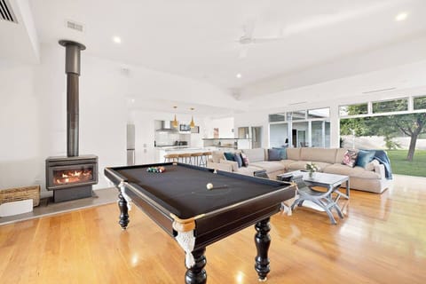 The entertainer's lounge offers a large, plush sofa, firewood heating, and a pool table.