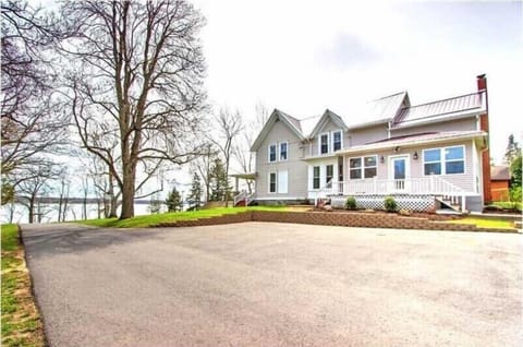 Parking 4-5 cars next to home and more parking in front of garage, near road.