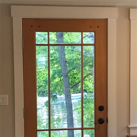Back door with screen door from kitchen & dining area to patio & Weber Gas Grill