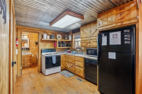 Fully stocked kitchen, pots, pans, dishes, spices, oil, flour, and sugar.