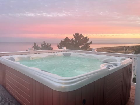Morning hot tub sunrise overlooking the bay