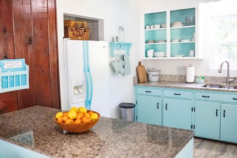 There is an ice-maker and cold water in the vintage-style fridge
