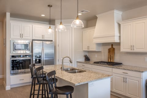 Kitchen - The Kitchen is complete with everything you will need for meal preparations including pots, pans, baking dishes, plates, cups, silverware, cutlery, and an assortment of cooking utensils.